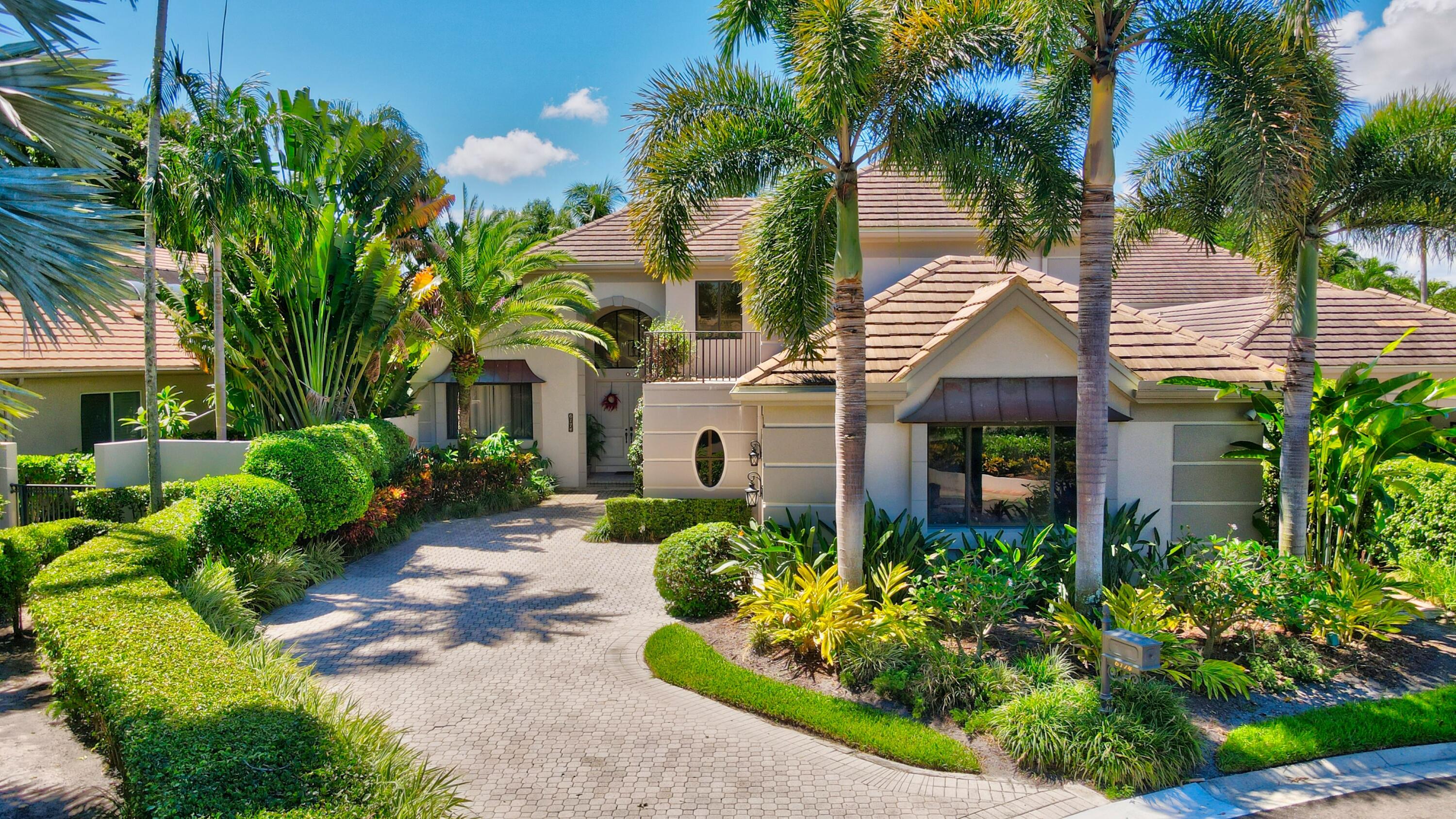6174 Northwest 24th Way Boca Raton, FL 33496 - Photo 2 of 58 a front view of a house with a garden