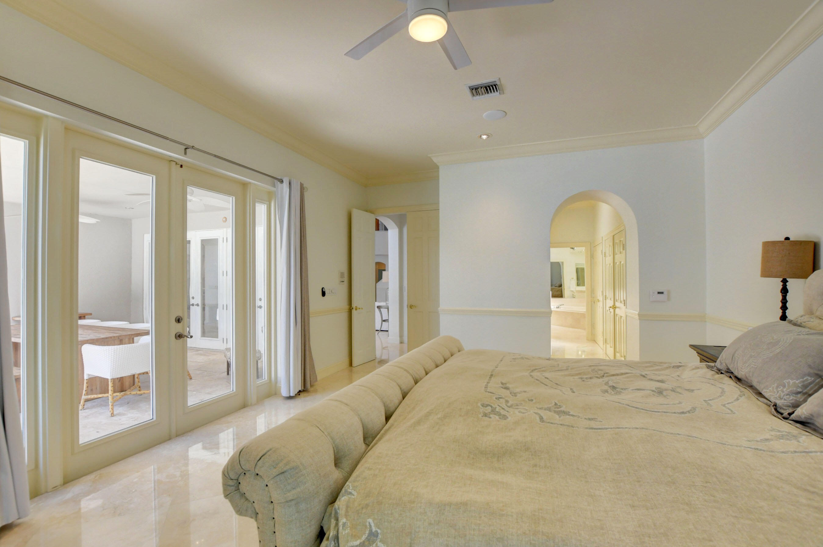 6174 Northwest 24th Way Boca Raton, FL 33496 - Photo 28 of 58 a bedroom with a bed and a painting on the wall