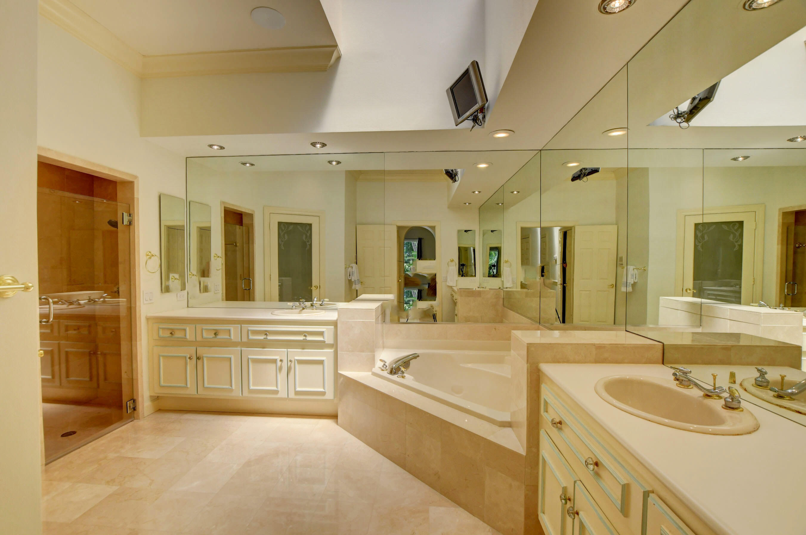 6174 Northwest 24th Way Boca Raton, FL 33496 - Photo 29 of 58 a large white bathroom with a tub a double vanity sink and mirror