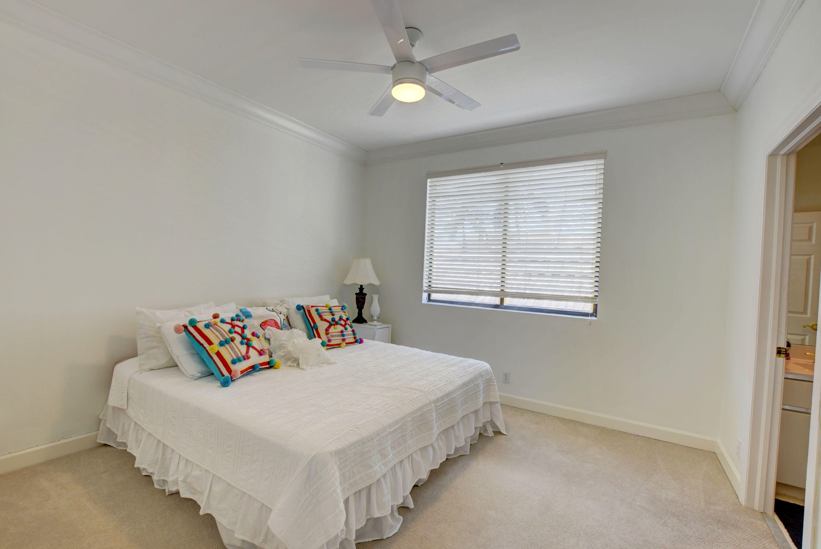 6174 Northwest 24th Way Boca Raton, FL 33496 - Photo 35 of 58 a bedroom with a bed and a window