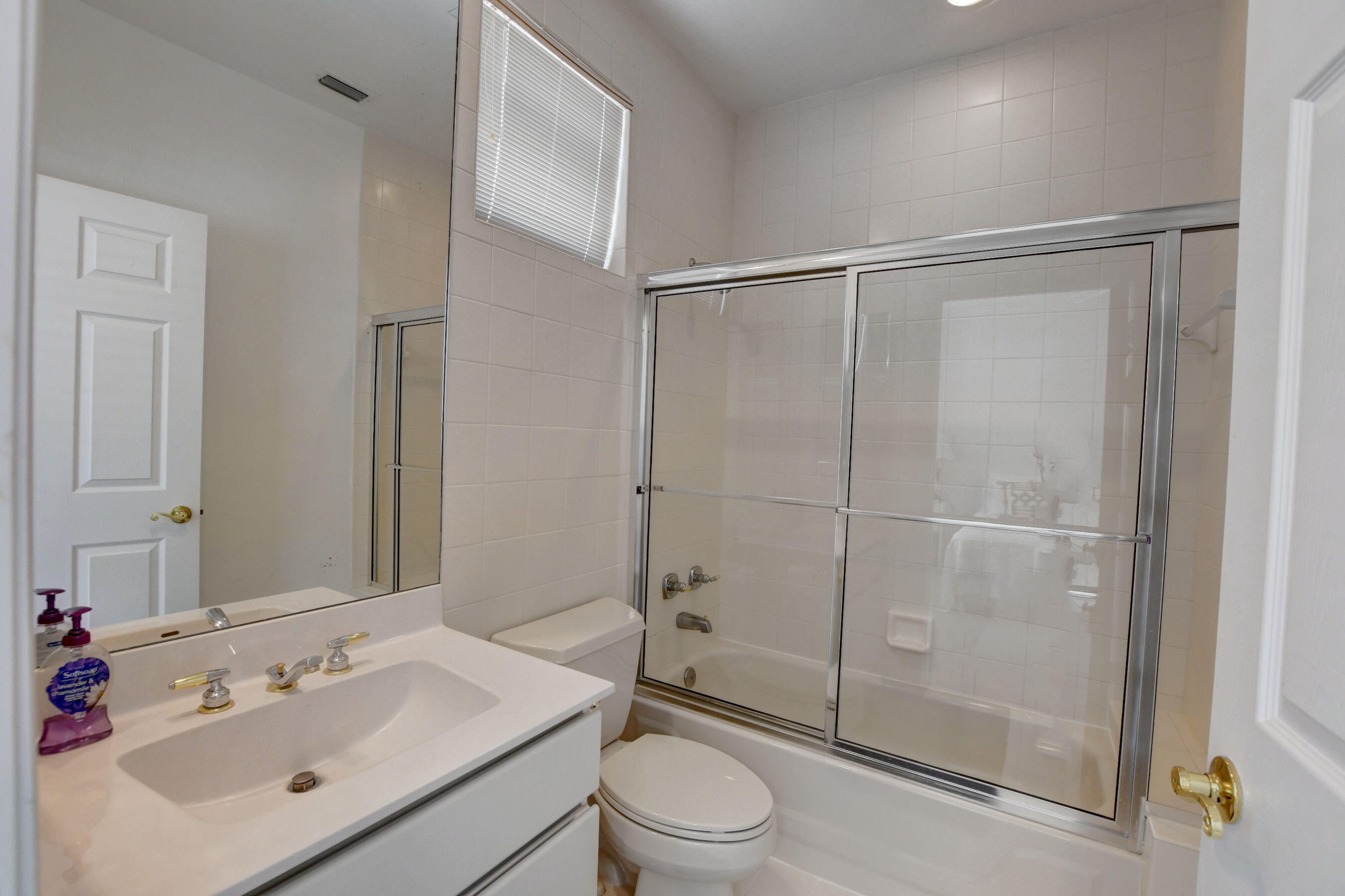 6174 Northwest 24th Way Boca Raton, FL 33496 - Photo 37 of 58 a bathroom with a sink toilet and shower