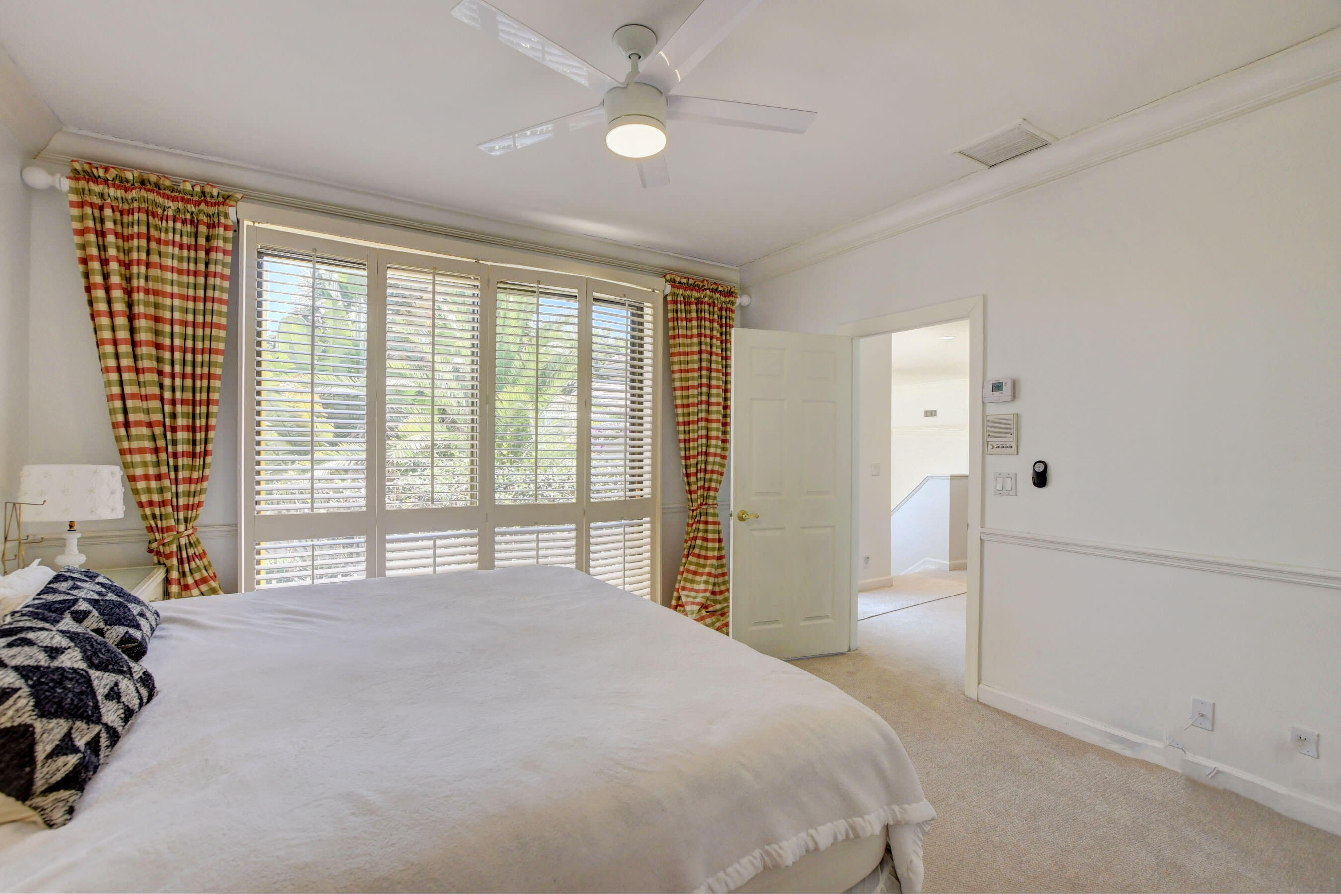 6174 Northwest 24th Way Boca Raton, FL 33496 - Photo 41 of 58 a bedroom with a bed and a large window