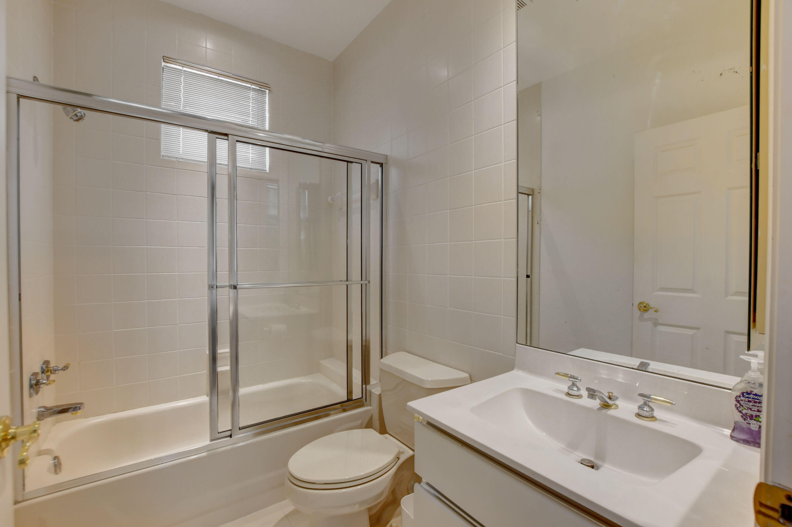 6174 Northwest 24th Way Boca Raton, FL 33496 - Photo 42 of 58 a bathroom with a sink mirror toilet and shower