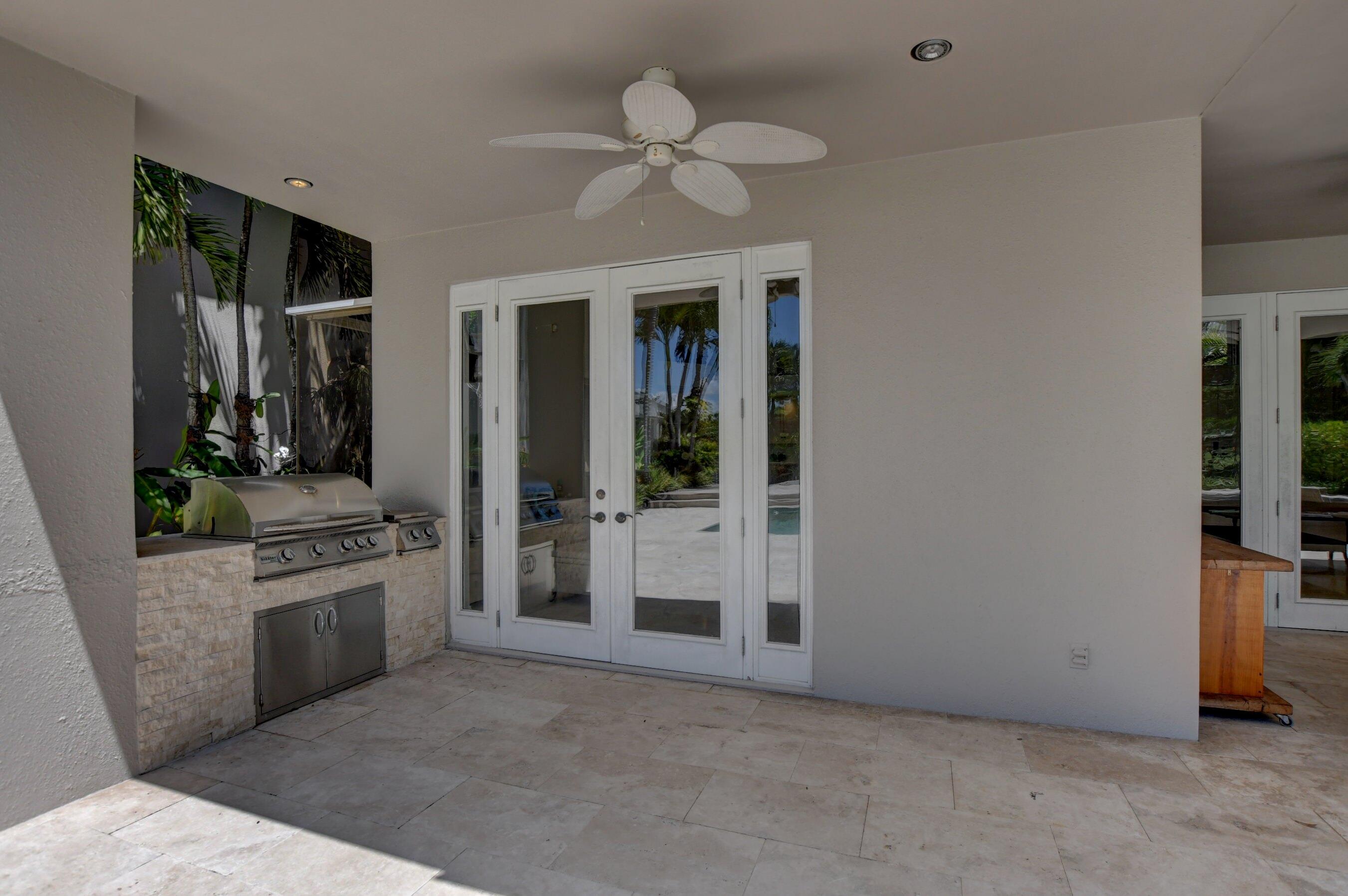 6174 Northwest 24th Way Boca Raton, FL 33496 - Photo 46 of 58 a view of a kitchen with a sink and a stove top oven
