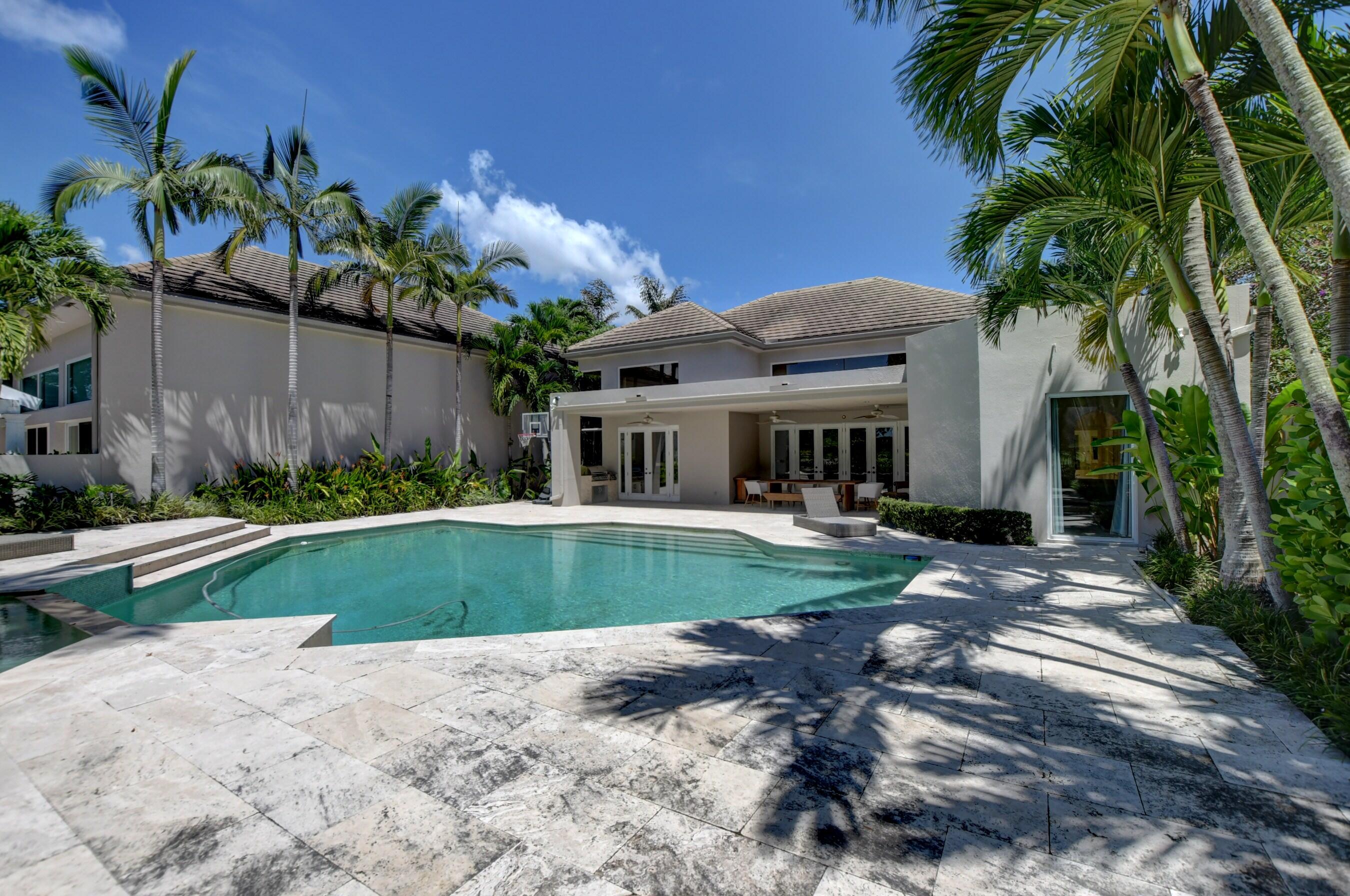 6174 Northwest 24th Way Boca Raton, FL 33496 - Photo 51 of 58 a front view of a house with a yard and potted plants