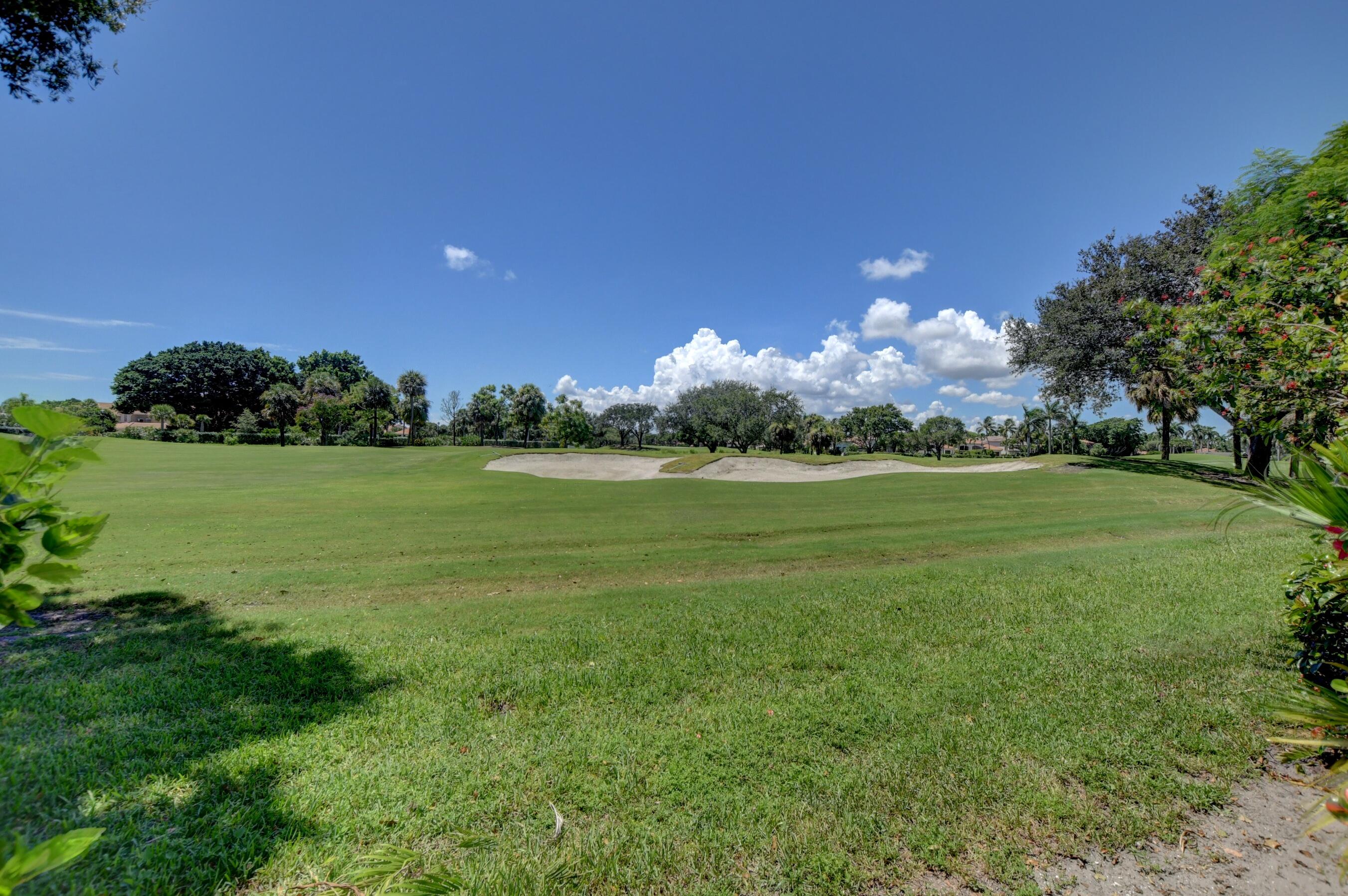 6174 Northwest 24th Way Boca Raton, FL 33496 - Photo 56 of 58 a view of a golf course with a lake