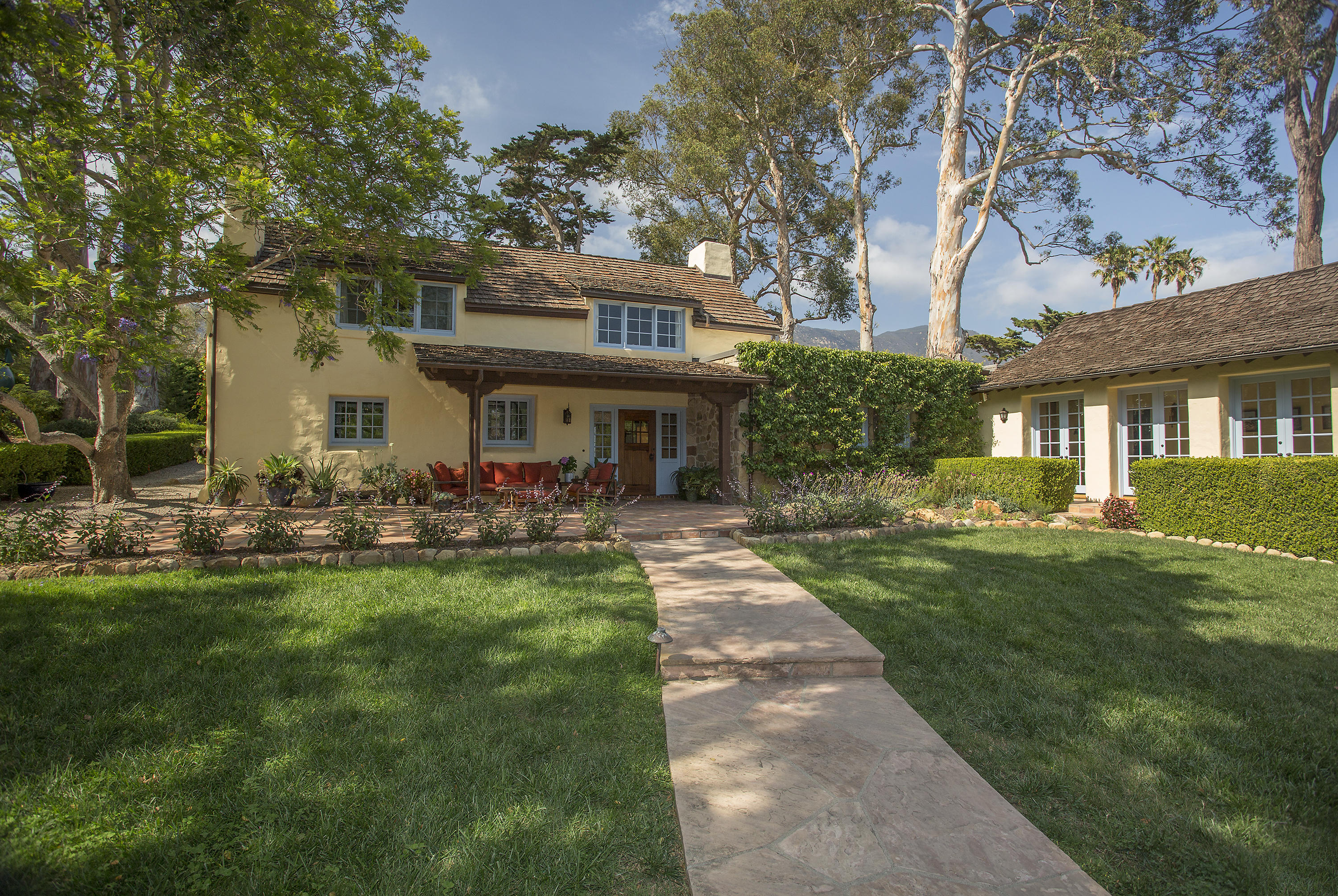 1420 East Valley Road Montecito, CA 93108 - Photo 1 of 17 a front view of a house with swimming pool having outdoor seating