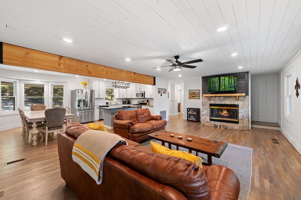 760 River Bend Lane Blue Ridge, GA 30513 - Photo 12 of 101 a living room with furniture a fireplace and a flat screen tv