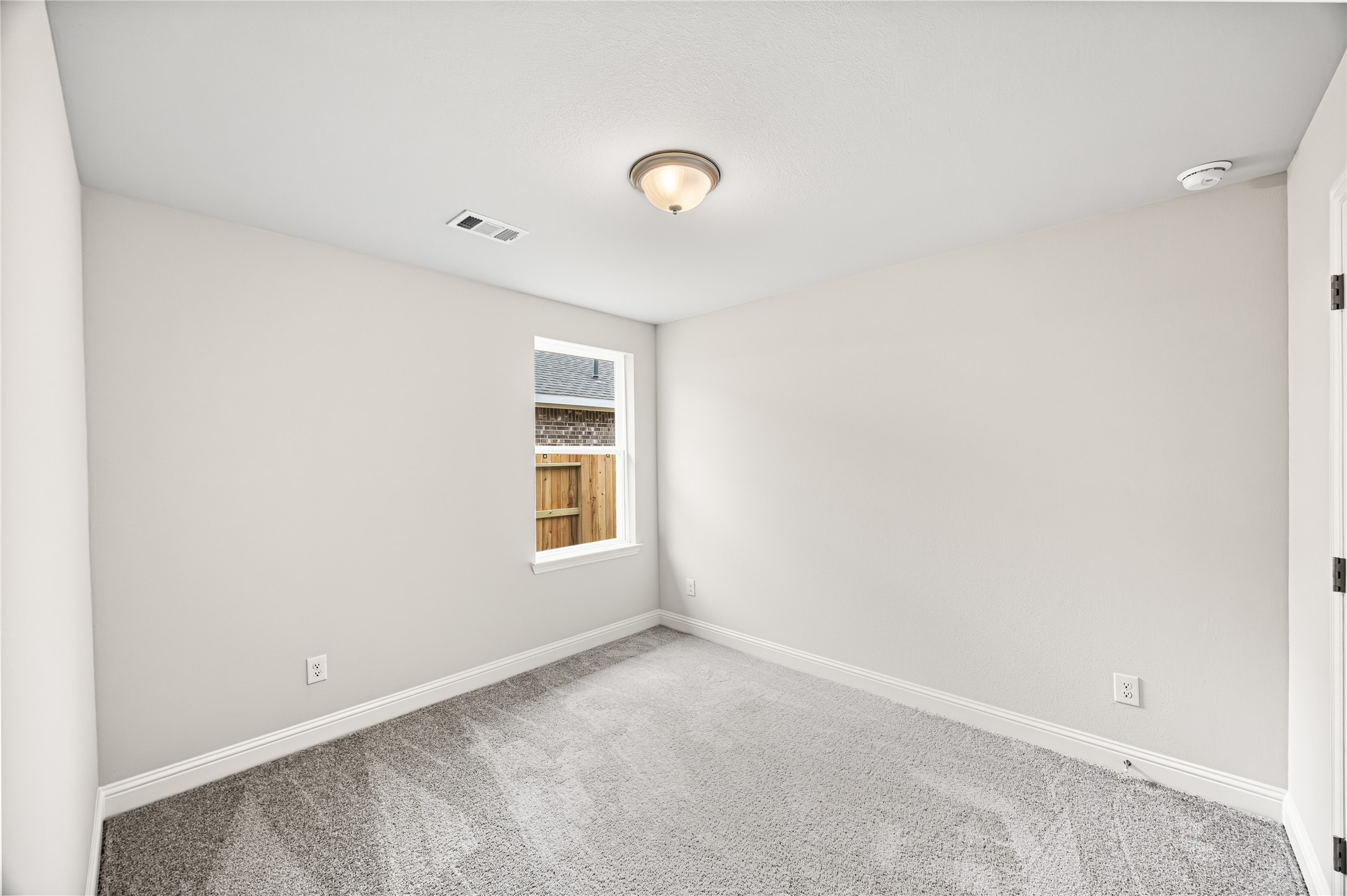 9476 Hard Rock Road Conroe, TX 77303 - Photo 12 of 13 an empty room with a window