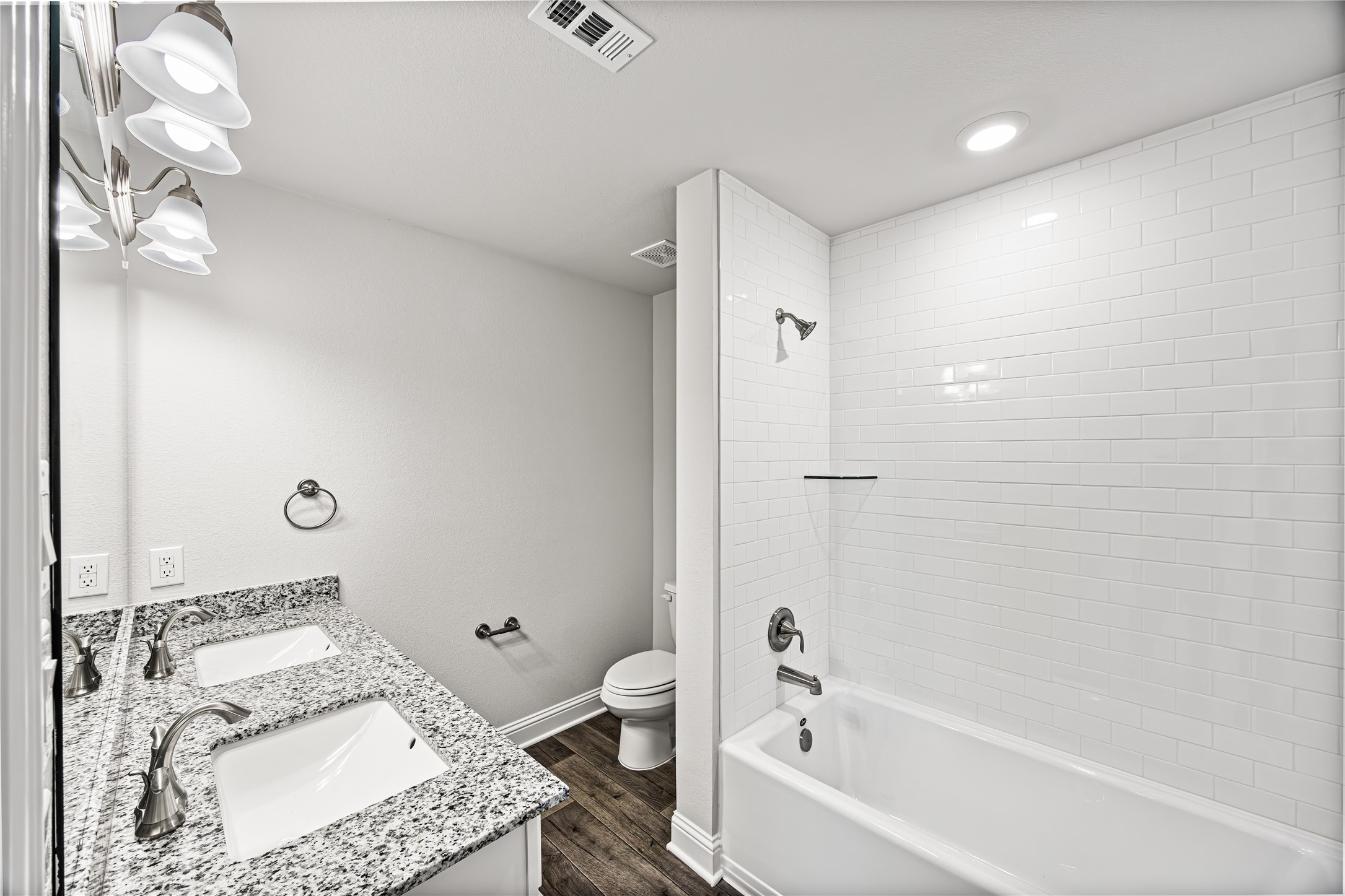 9476 Hard Rock Road Conroe, TX 77303 - Photo 13 of 13 a bathroom with a granite countertop sink a toilet and bathtub