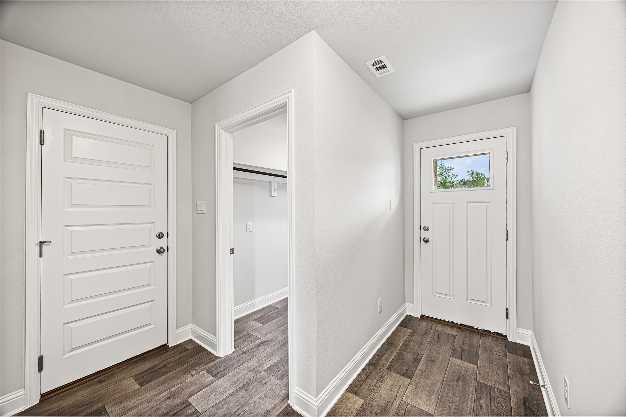 9476 Hard Rock Road Conroe, TX 77303 - Photo 2 of 13 an empty room with wooden floor closet and windows