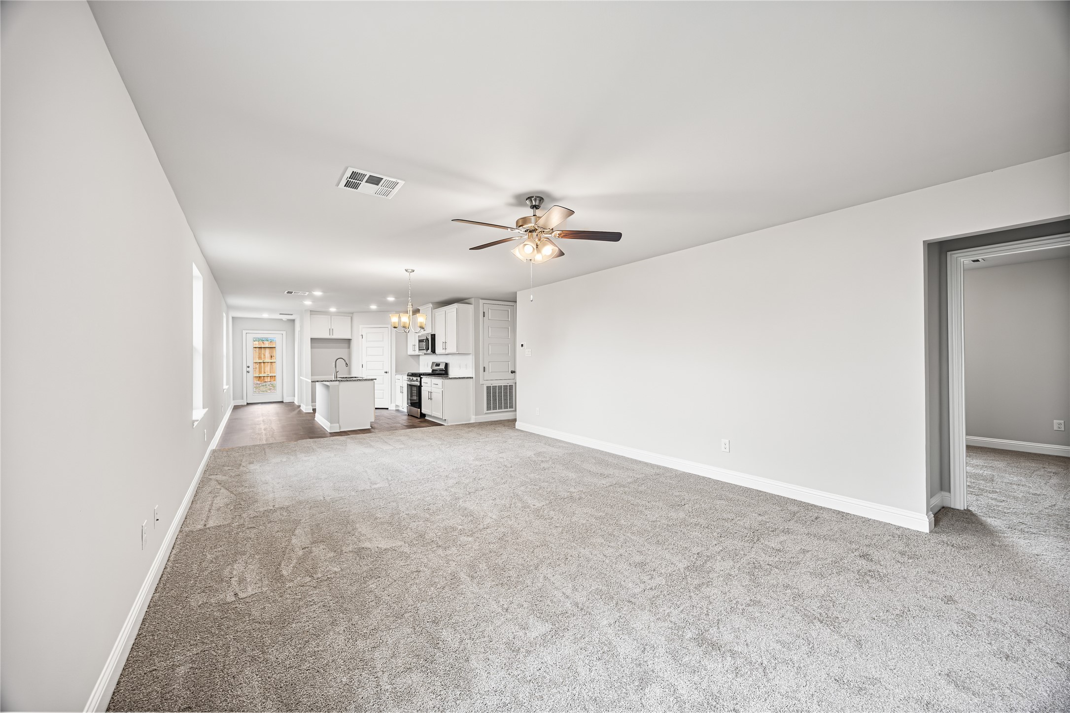 9476 Hard Rock Road Conroe, TX 77303 - Photo 4 of 13 a view of a livingroom and a kitchen