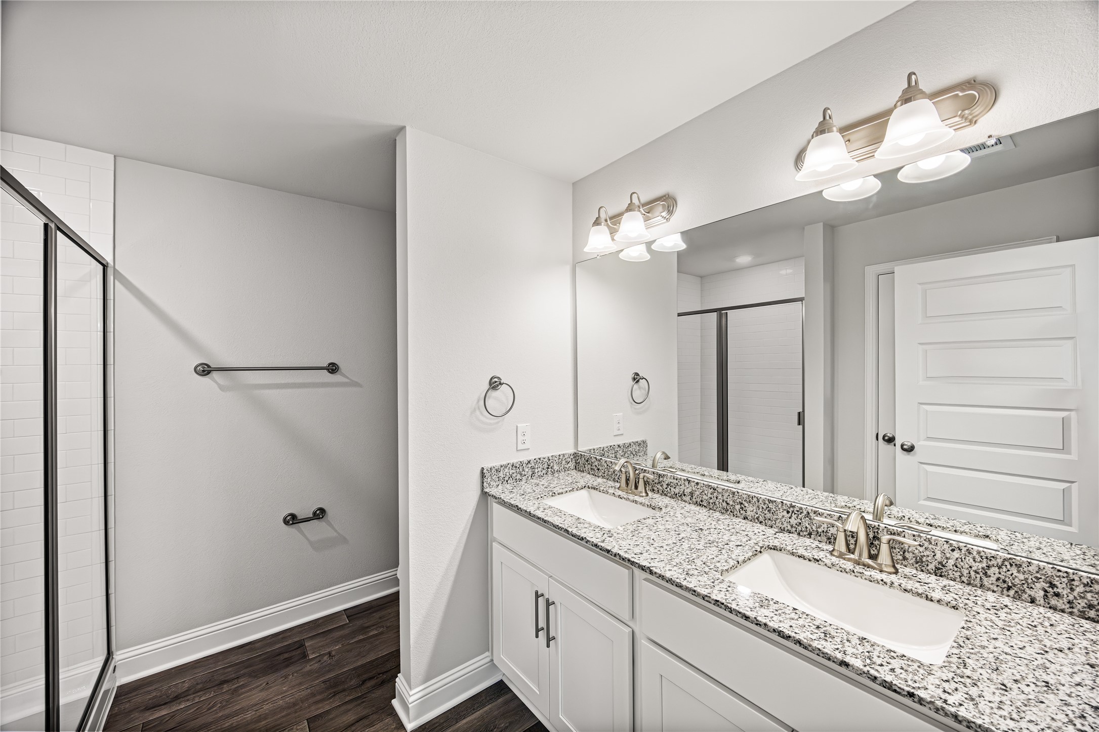 9476 Hard Rock Road Conroe, TX 77303 - Photo 8 of 13 a bathroom with a granite countertop sink a large mirror and a shower
