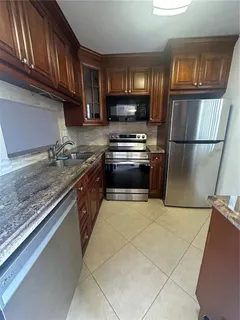 a bathroom with a sink a toilet a mirror and shower