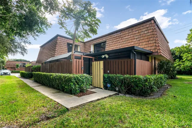a front view of a house with a yard and outdoor seating
