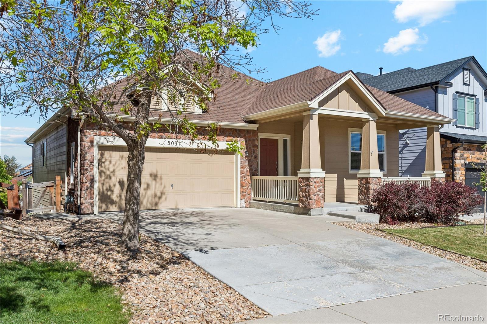 5031 South Rome Street Aurora, CO 80015 - Photo 2 of 39 a front view of a house with a yard and garage