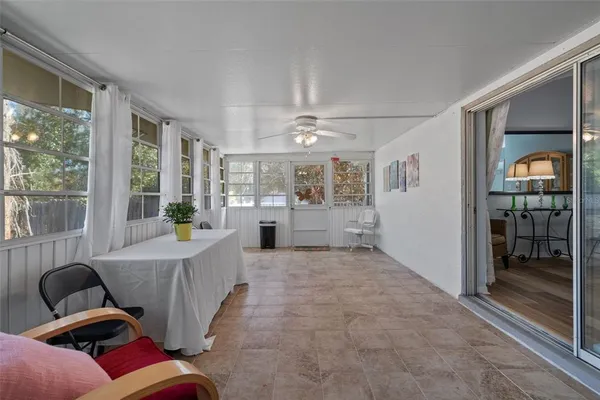 a living room with furniture and a floor to ceiling window