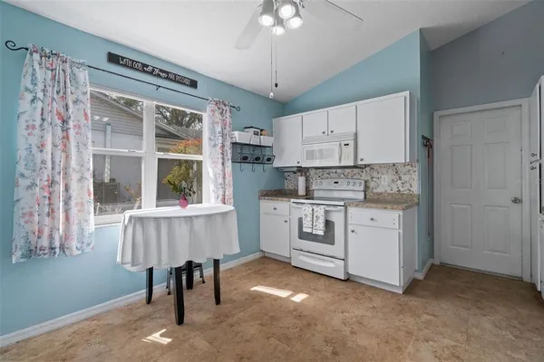 a kitchen with a stove a sink and a refrigerator