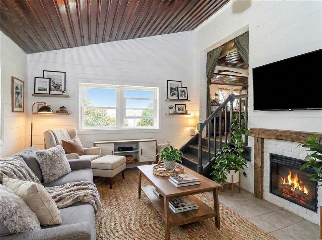 636 Holmdel Road Hazlet, NJ 07730 - Photo 13 of 47 a living room with furniture a fireplace and a flat screen tv