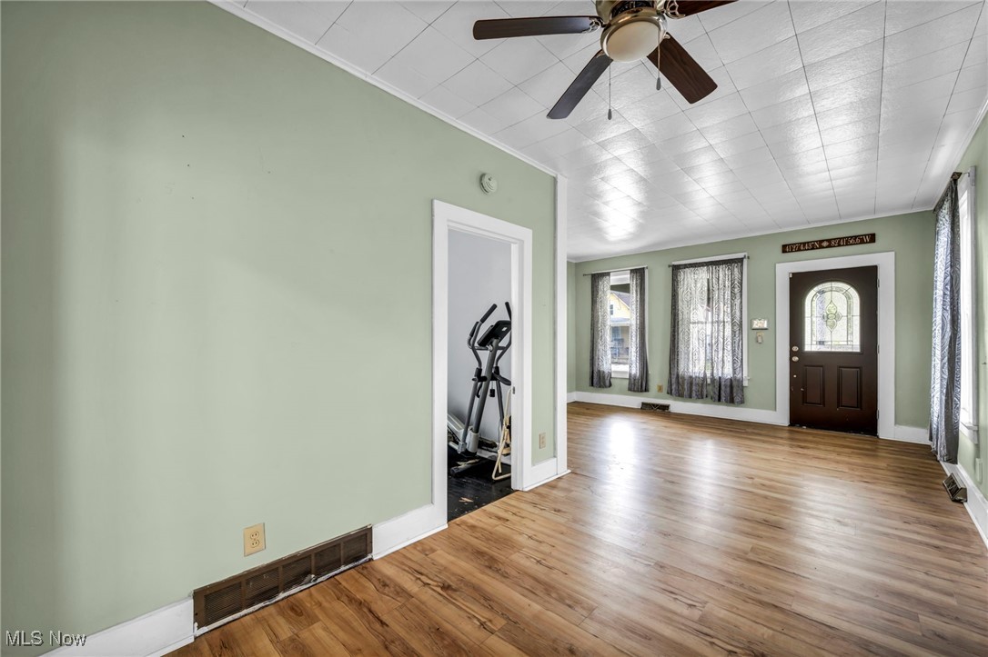 816 Perry Street Sandusky, OH 44870 - Photo 11 of 38 Foyer entrance with wood finished floors, a ceiling fan, and crown molding