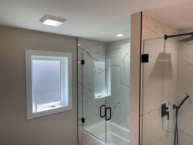 a bathroom with a shower and a tub