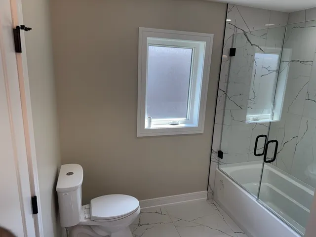a bathroom with a toilet and a bathtub