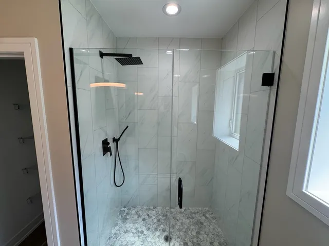 a bathroom with a glass shower door