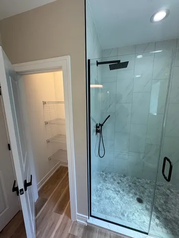 a bathroom with a glass shower door