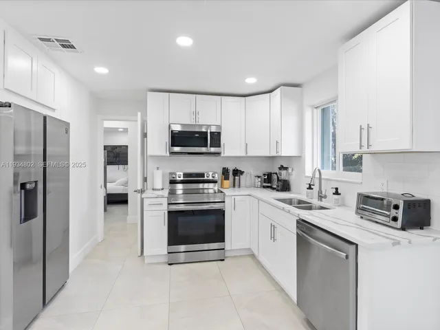 a kitchen with cabinets stainless steel appliances and a counter top space
