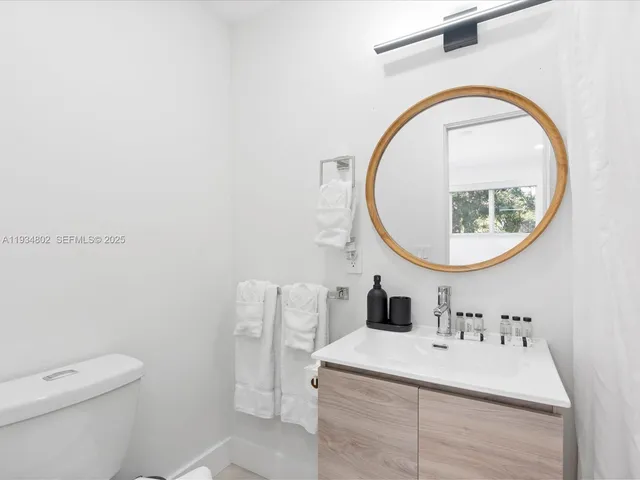 a bathroom with a sink a mirror and a toilet
