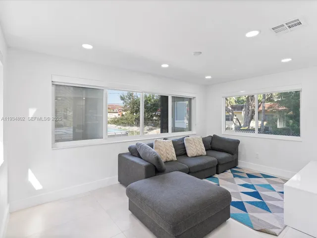 a living room with furniture and a large window