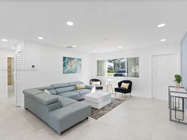 a living room with furniture and a large window