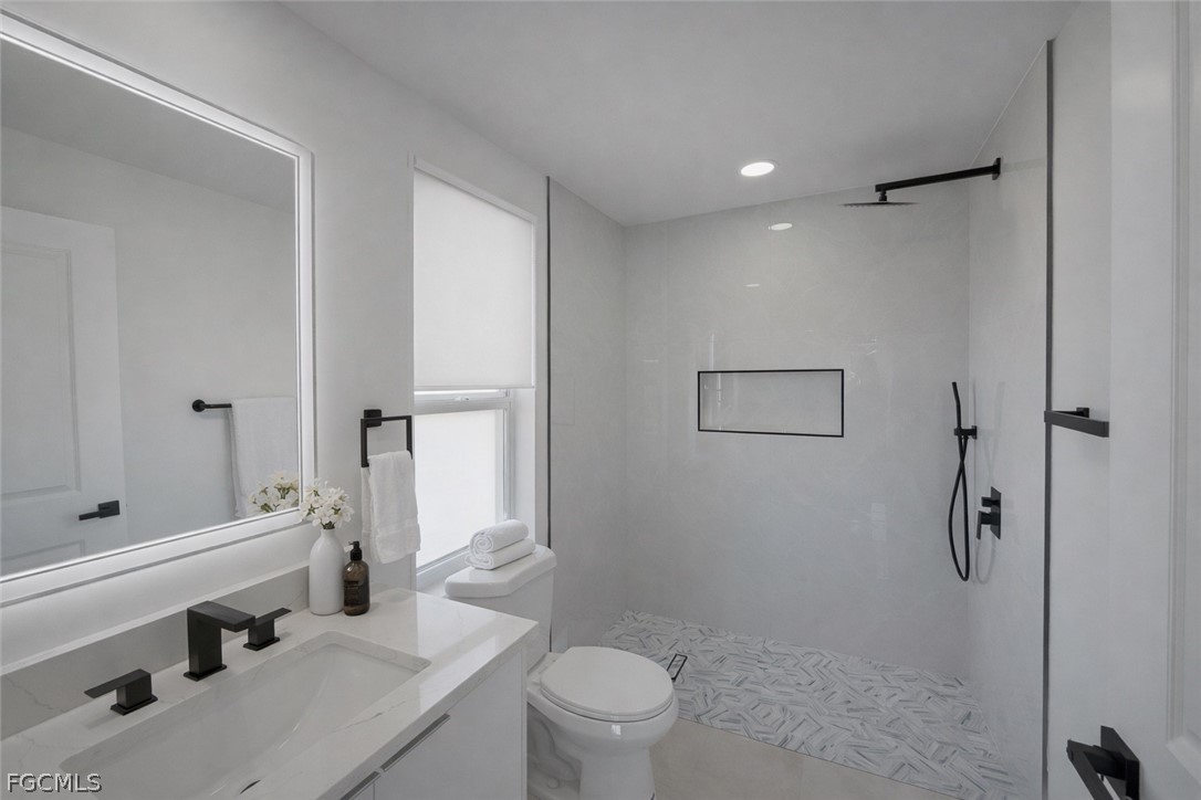 4529 18th Street Southwest Lehigh Acres, FL 33973 - Photo 12 of 50 a bathroom with a sink a toilet and shower