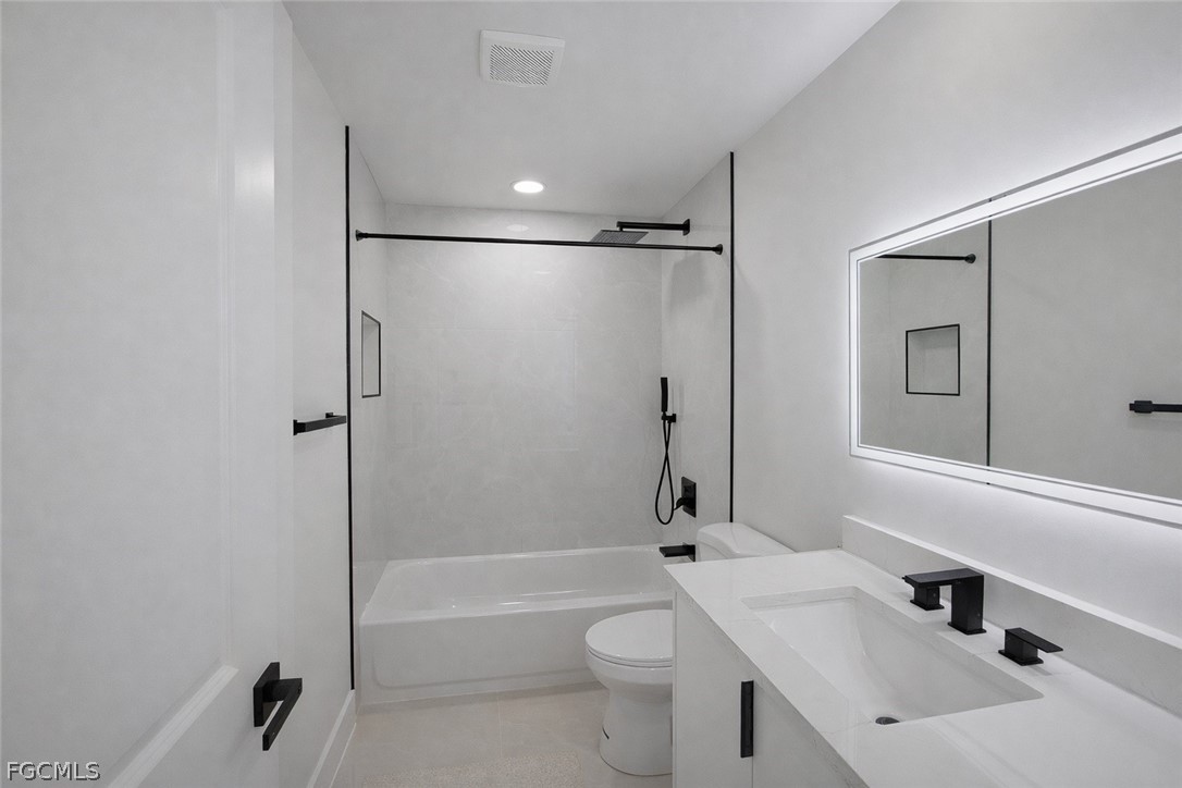 4529 18th Street Southwest Lehigh Acres, FL 33973 - Photo 18 of 50 a bathroom with a sink toilet and shower