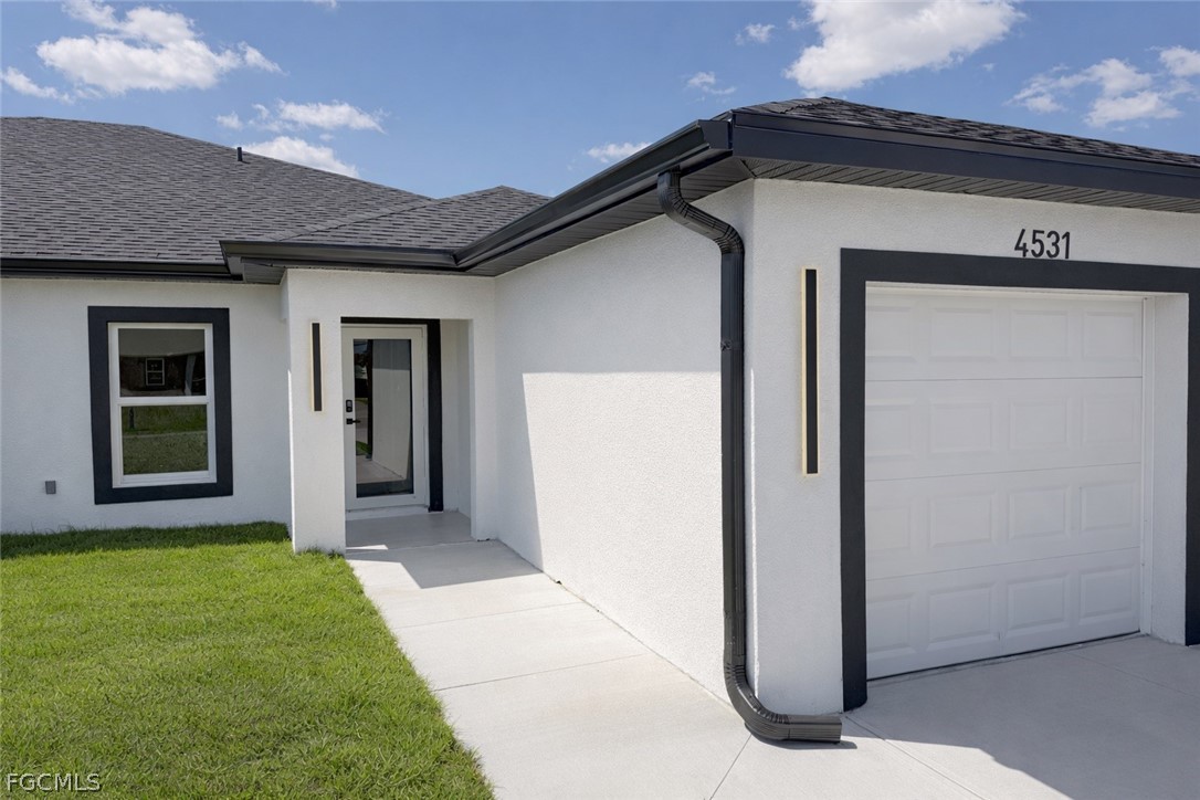 4529 18th Street Southwest Lehigh Acres, FL 33973 - Photo 2 of 50 a front view of a house with a yard