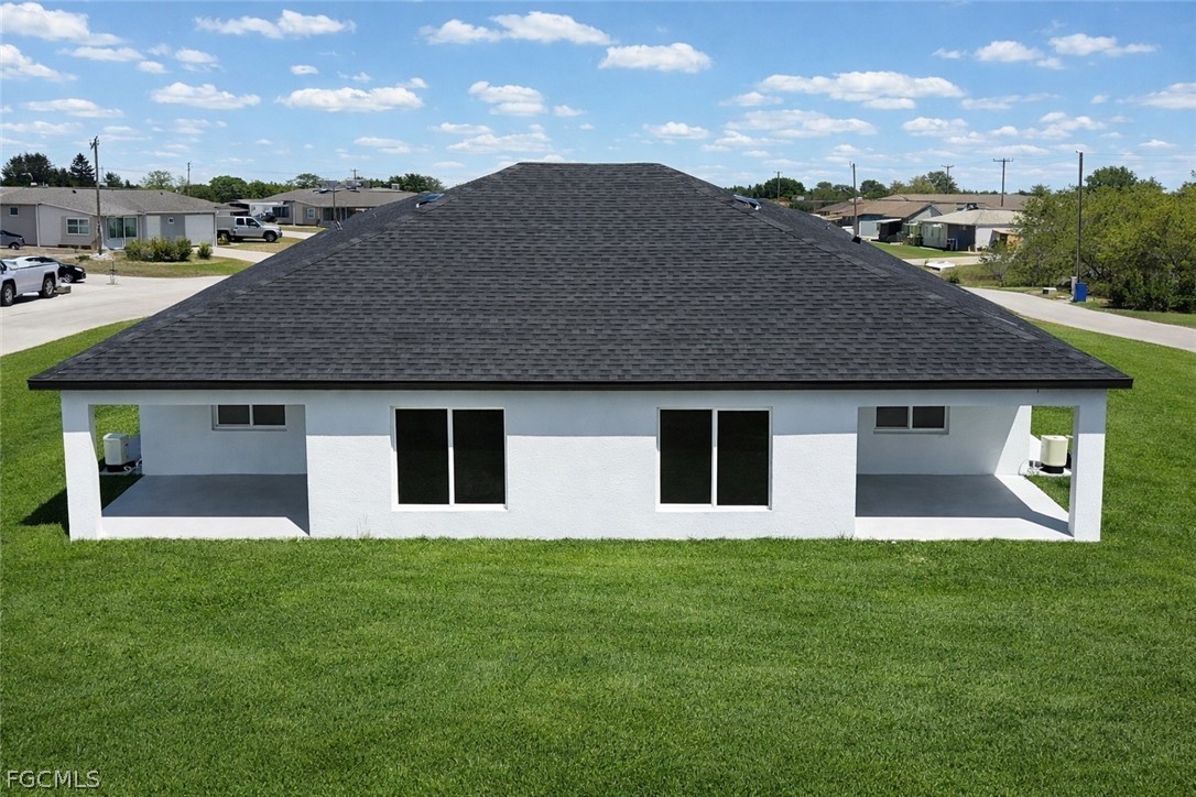 4529 18th Street Southwest Lehigh Acres, FL 33973 - Photo 24 of 50 a front view of a house with garden