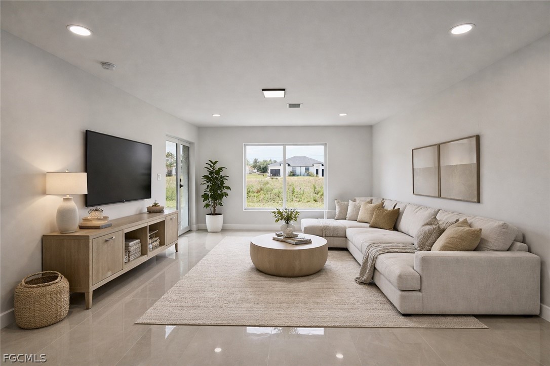 4529 18th Street Southwest Lehigh Acres, FL 33973 - Photo 28 of 50 a living room with furniture and a flat screen tv
