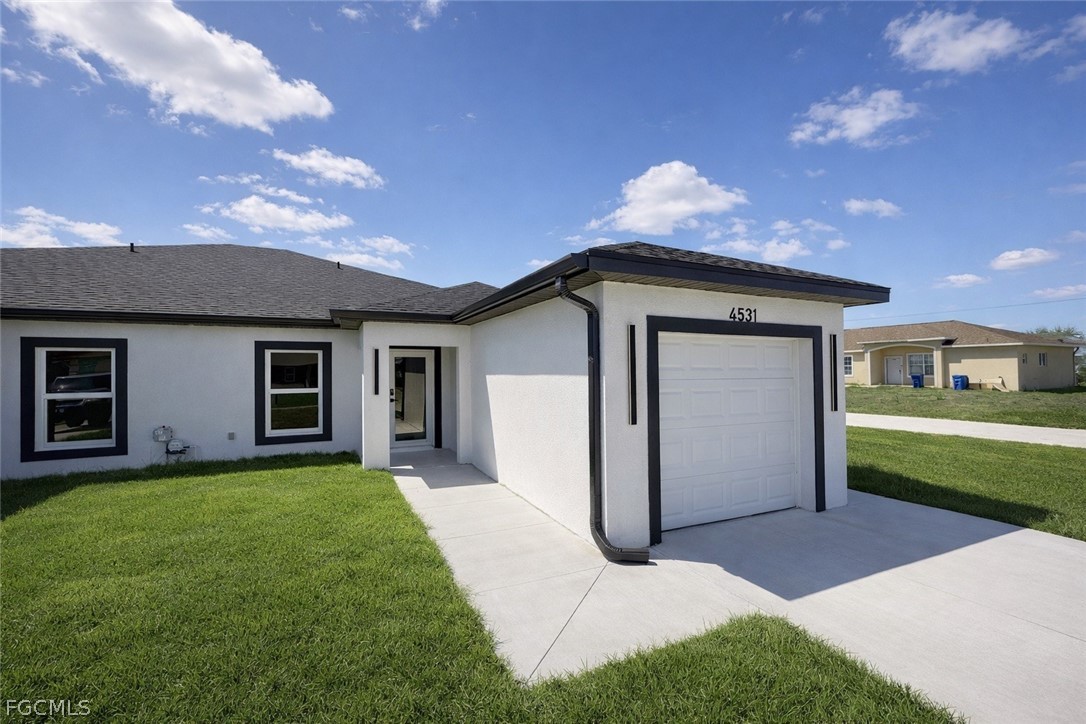 4529 18th Street Southwest Lehigh Acres, FL 33973 - Photo 3 of 50 a house view with a garden space