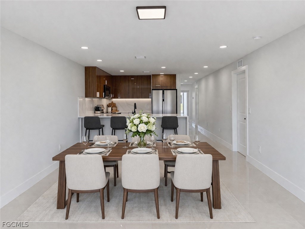 4529 18th Street Southwest Lehigh Acres, FL 33973 - Photo 32 of 50 a view of a dining room with furniture