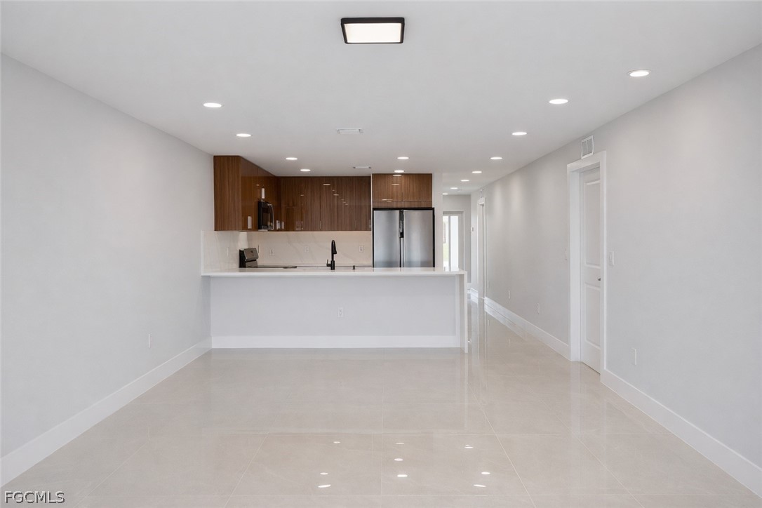 4529 18th Street Southwest Lehigh Acres, FL 33973 - Photo 33 of 50 a view of kitchen with kitchen island and stainless steel appliances