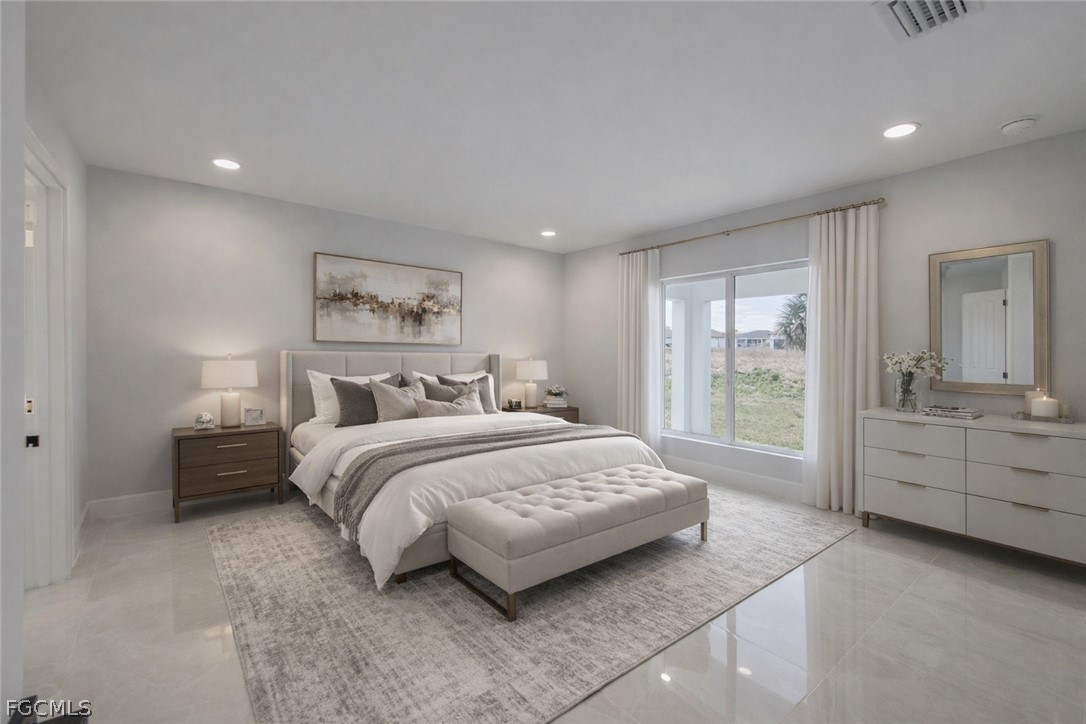 4529 18th Street Southwest Lehigh Acres, FL 33973 - Photo 34 of 50 a spacious bedroom with a large bed and a desk