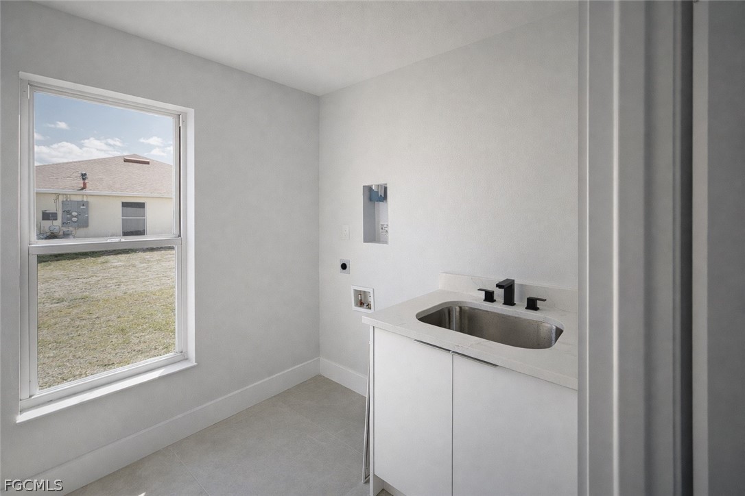 4529 18th Street Southwest Lehigh Acres, FL 33973 - Photo 45 of 50 a kitchen with a sink and cabinets