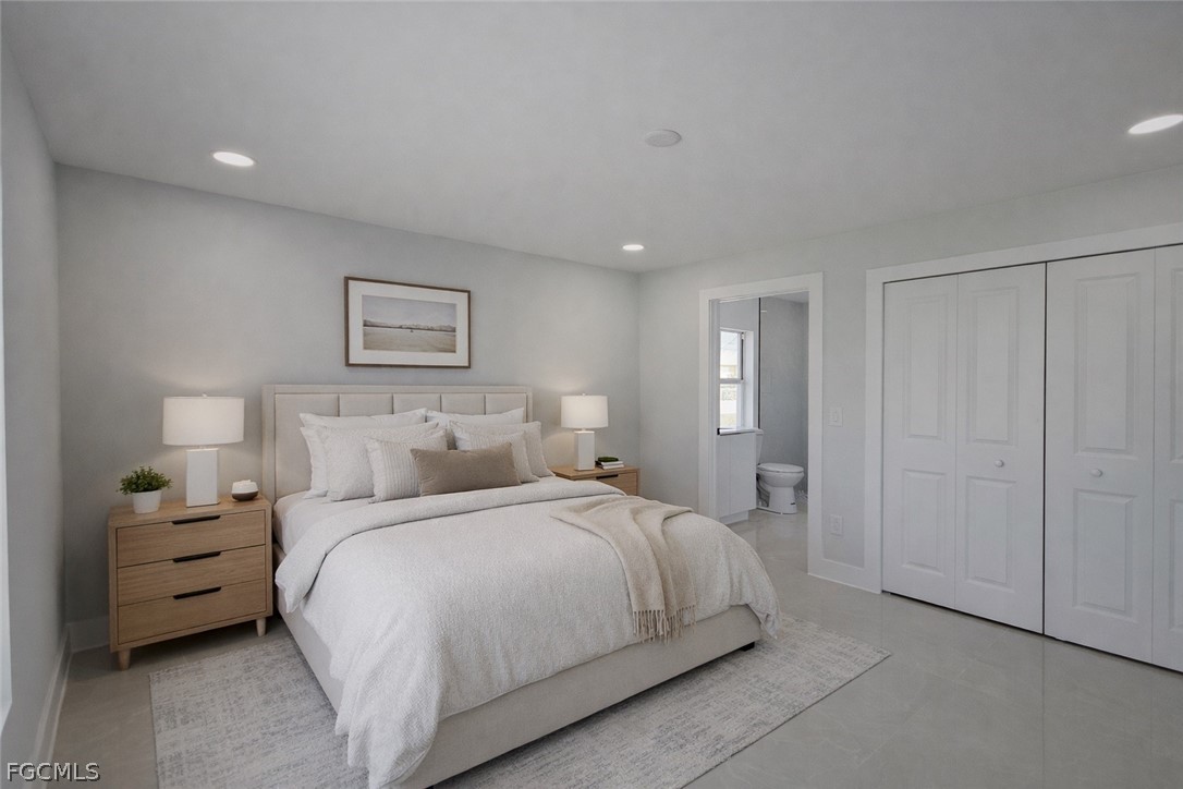 4529 18th Street Southwest Lehigh Acres, FL 33973 - Photo 9 of 50 a bedroom with a bed and a night stand