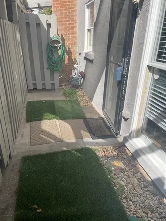 a view of a small yard in front of a house with a fountain