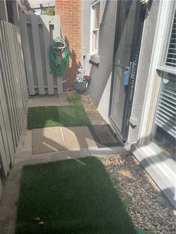a view of a small yard in front of a house with a fountain