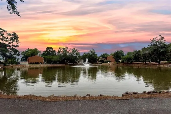 a view of a lake with houses in the back