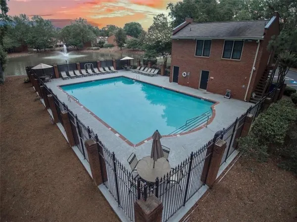 an aerial view of a house with outdoor space and lake view