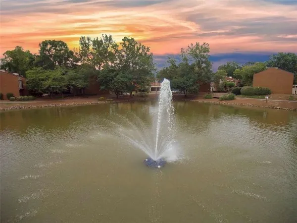 a view of a lake with houses in the back