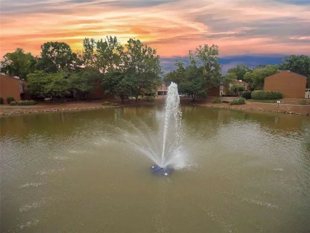 a view of a lake with houses in the back