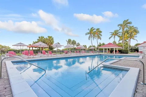 a view of swimming pool with outdoor seating and deck in the back